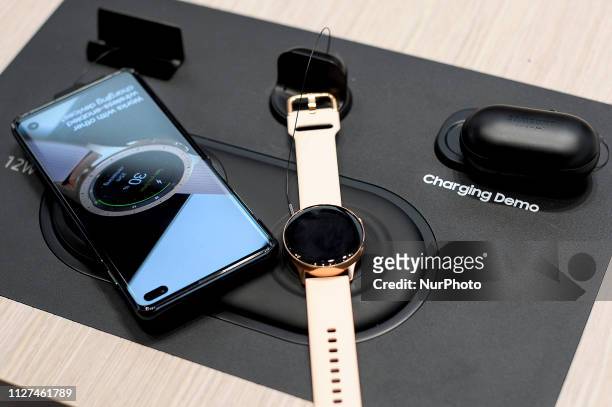 Demo exhibited of Samsung Wireless Charger Duo Pad, charging a Samsung Galaxy S10+, Samsung Galaxy Watch Active and Samsung Galaxy Buds, during the...