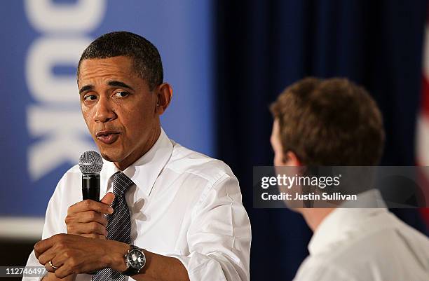 President Barack Obama talks with Facebook CEO Mark Zuckerberg during a town hall style meeting at Facebook headquarters on April 20, 2011 in Palo...