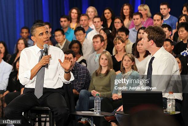 President Barack Obama talks with Facebook CEO Mark Zuckerberg during a town hall style meeting at Facebook headquarters on April 20, 2011 in Palo...