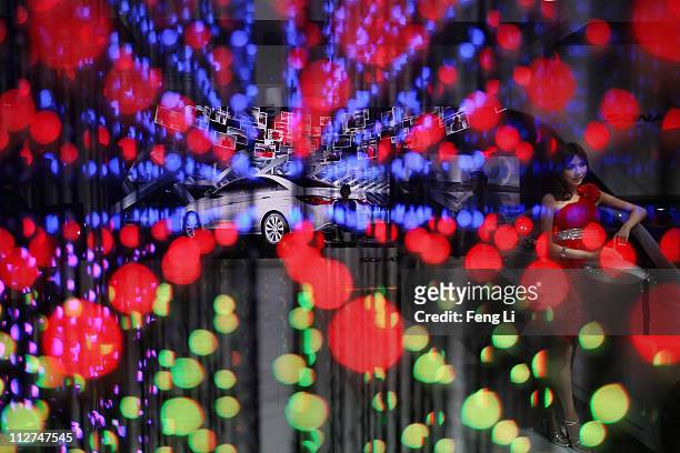 Model poses beside a Hyundai car during the media day of the Shanghai International Automobile Industry Exhibition at Shanghai New International Expo...