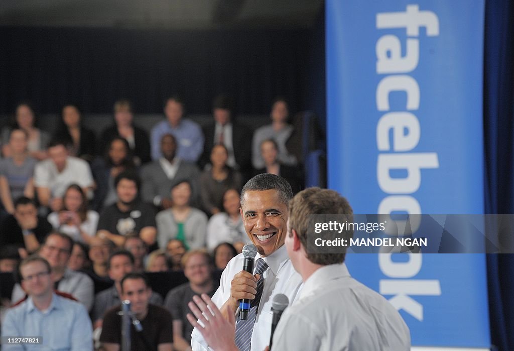 US President Barack Obama looks at Faceb