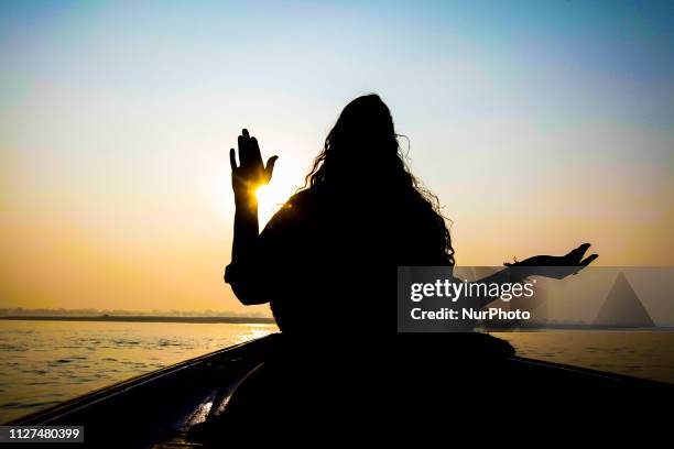 Early morning Yoga session with yogi instructor Smriti on a boat in Ganga river during the sunrise in Varanasi, Uttar Pradesh, India