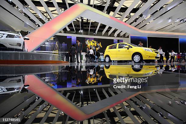 People visit the exhibition area of the Chevrolet during the media day of the Shanghai International Automobile Industry Exhibition at Shanghai New...