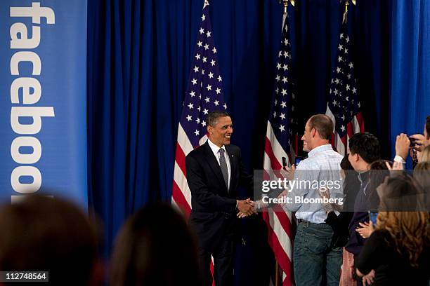 President Barack Obama greets attendees as he arrives for a town hall event at Facebook Inc. Headquarters in Palo Alto, California, U.S., on...