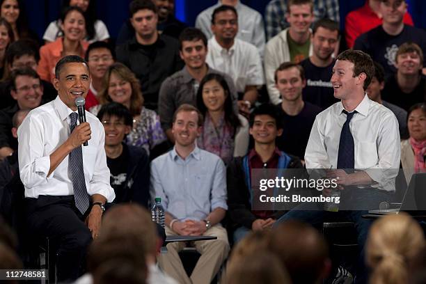 President Barack Obama, left, speaks while Mark Zuckerberg, co-founder and chief executive officer of Facebook Inc., smiles during a town hall event...