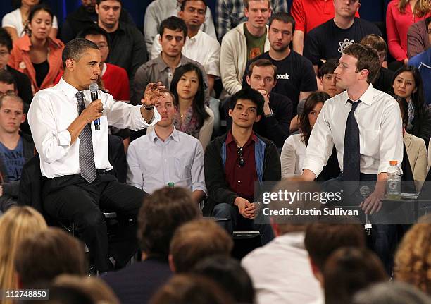 President Barack Obama talks with Facebook CEO Mark Zuckerberg during a town hall style meeting at Facebook headquarters on April 20, 2011 in Palo...