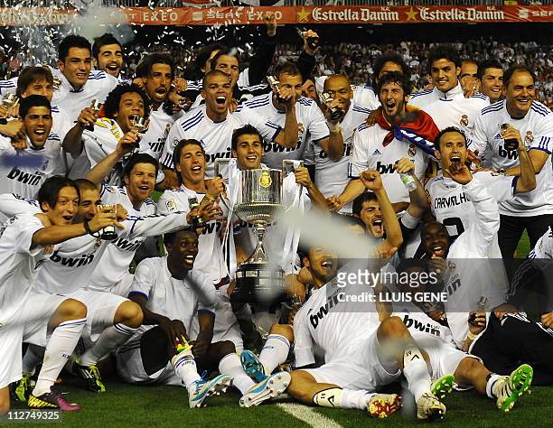 Real Madrid's players celebrate with the trophy after winning the Spanish Cup final match Real Madrid against Barcelona at the Mestalla stadium in...