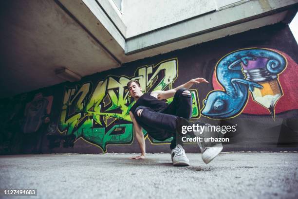 graffiti and break-dancer - acrobatic activity stock pictures, royalty-free photos & images