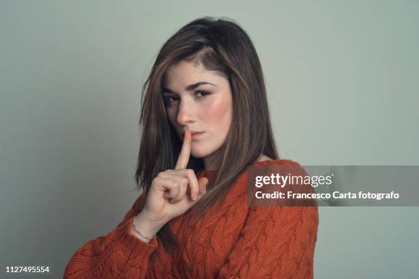 quiet please - woman with finger on lips stock pictures, royalty-free photos & images