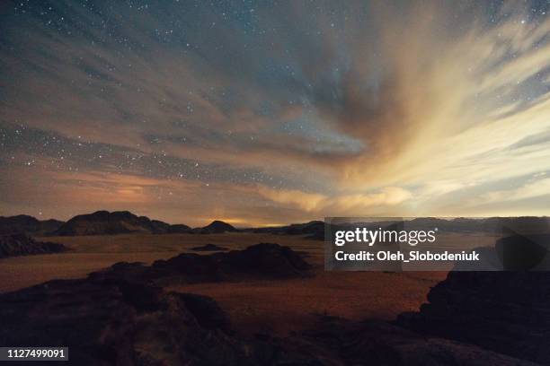 scenic view of wadi rum desert at night - dramatic night sky stock pictures, royalty-free photos & images