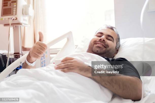 happy young man in the hospital - heart surgery stock pictures, royalty-free photos & images