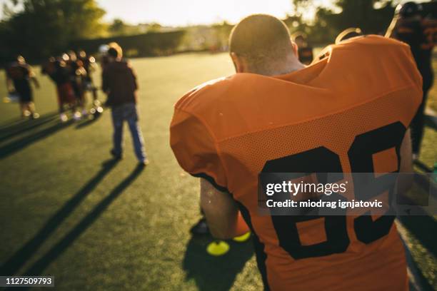 getting dressed for training - blank sports jersey stock pictures, royalty-free photos & images