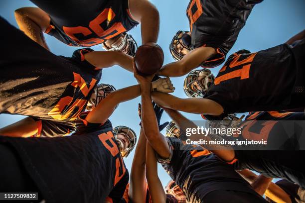 team huddle - football huddle stock pictures, royalty-free photos & images