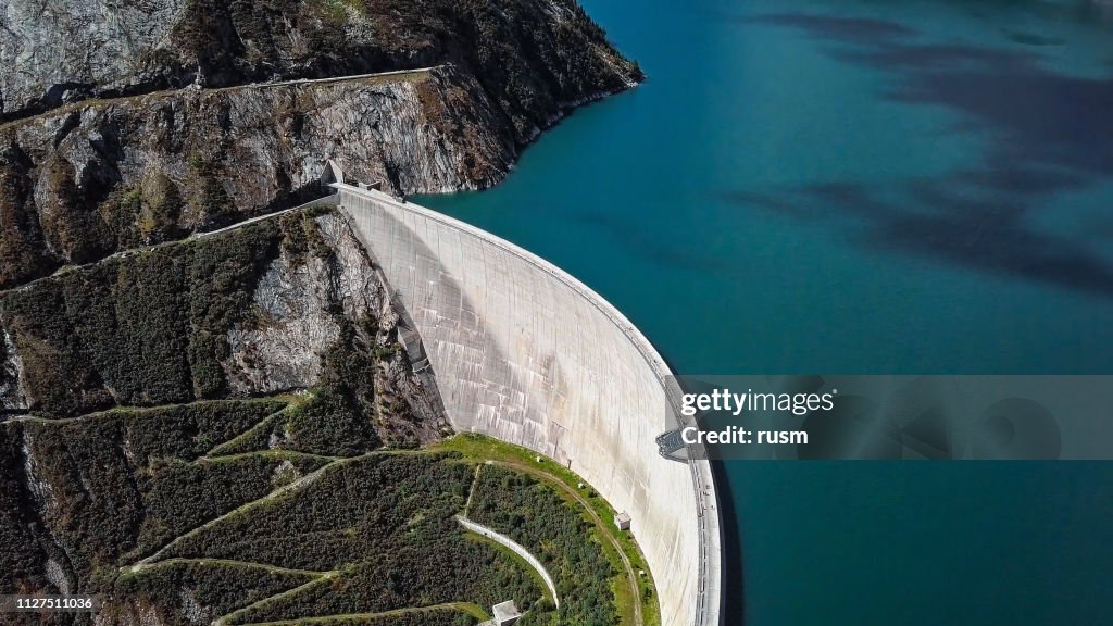Top aerial view of Kolnbrein Dam and Malta road on Kolnbreinspeicher lake in Carinthia, Austria.