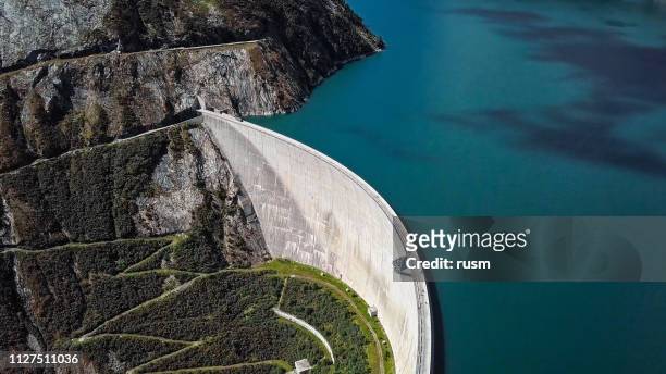 top aerial view of kolnbrein dam and malta road on kolnbreinspeicher lake in carinthia, austria. - reservoir stock pictures, royalty-free photos & images