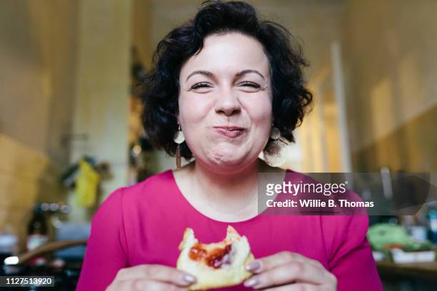 woman enjoying her breakfast - indulgence stockfoto's en -beelden