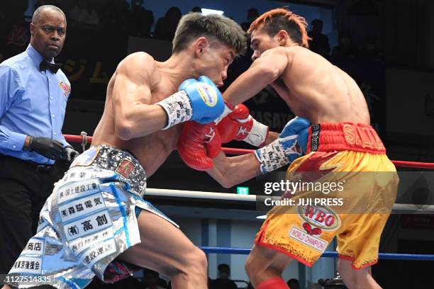 Japan's Masataka Taniguchi and Vic Saludar of Philippines fight during their WBO minimum weight boxing title bout in Tokyo on February 26, 2019. /...