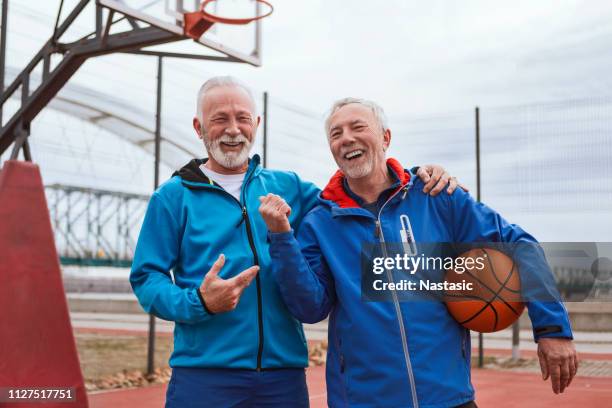 two seniors getting ready to play basketball - older sibling stock pictures, royalty-free photos & images