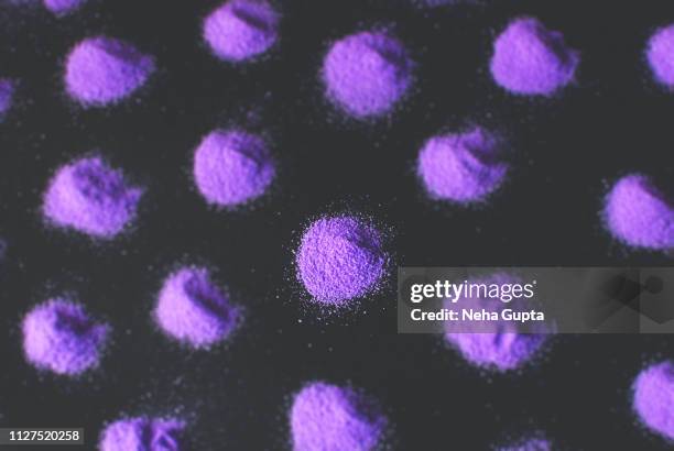 splashes of purple powder paint on a black background - delhi smog stock pictures, royalty-free photos & images