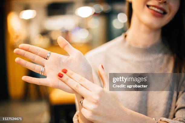 lovely woman showing a sign - signer stock pictures, royalty-free photos & images