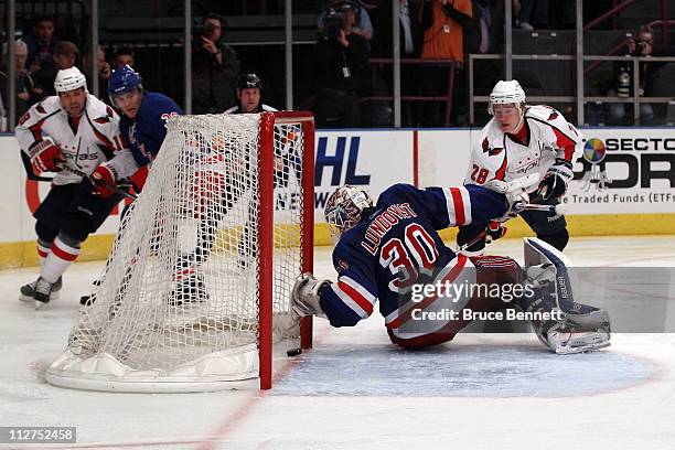 Alexander Semin of the Washington Capitals scores a goal in the third period against goalie Henrik Lundqvist of the New York Rangers in Game Four of...