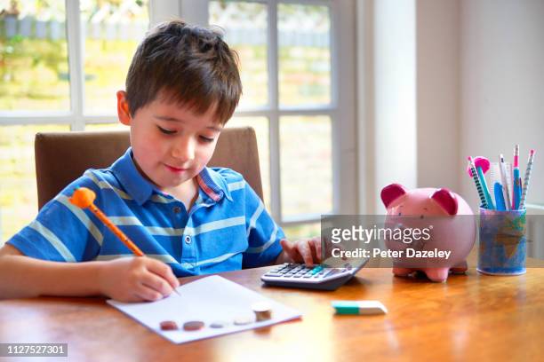 boy counting his pocket money - boys money stock pictures, royalty-free photos & images