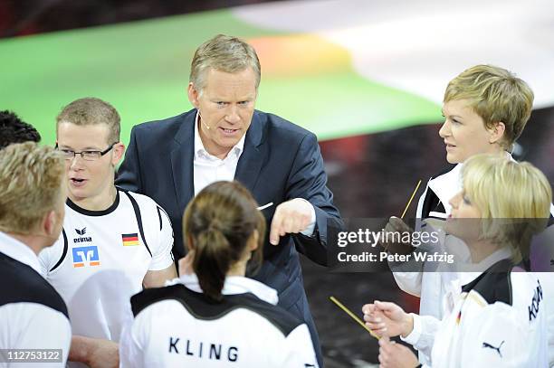 Presenter Johannes B. Kerner discusses the rules with the german team members during the 'Deutschland Gegen Italien' TV Show on April 20, 2011 in...