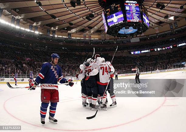 Marcus Johansson and John Carlson of the Washington Capitals celebrate with their teammates after Johansson scored a goal in the third period to tie...