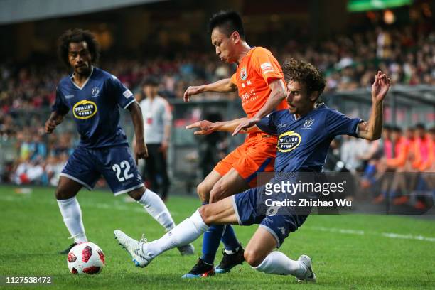 Zhang Chi of Shandong Luneng Taishan FC competes with Albert Riera of Auckland City FC during Tonghai Financial Chinese New Year Cup 2019 between...