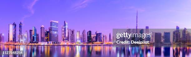 panoramic view of the downtown dubai city skyline and business park at sunset, united arab emirates. - panoramic skyline stock pictures, royalty-free photos & images