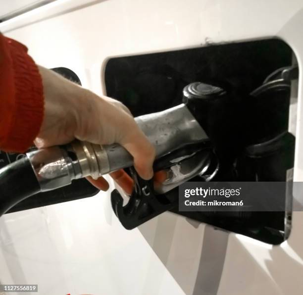 hand refilling the bus with fuel - diesel fuel stock pictures, royalty-free photos & images