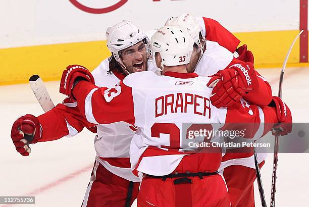 Patrick Eaves of the Detroit Red Wings celebrates with teammates Kris Draper and Darren Helm after scoring a first period goal against the Phoenix...