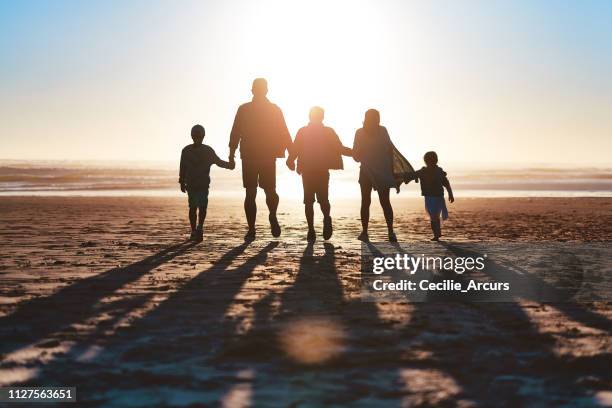 never miss a sunset - family in silhouette stock pictures, royalty-free photos & images