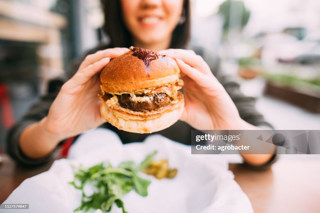 Woman eating beef burger