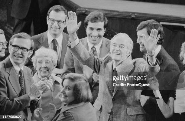 American politician US Senator Hubert H Humphrey raises his hands, surrounded by smiling collegues, Washington DC, November 3, 1977.