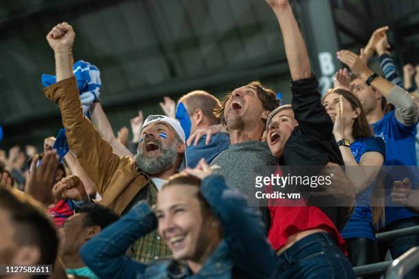 excited friends celebrating success of their team - crowd cheering stock pictures, royalty-free photos & images