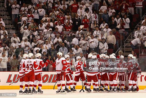 Mike Modano of the Detroit Red Wings celebrates with teammates after defeating the Phoenix Coyotes in Game Four of the Western Conference...