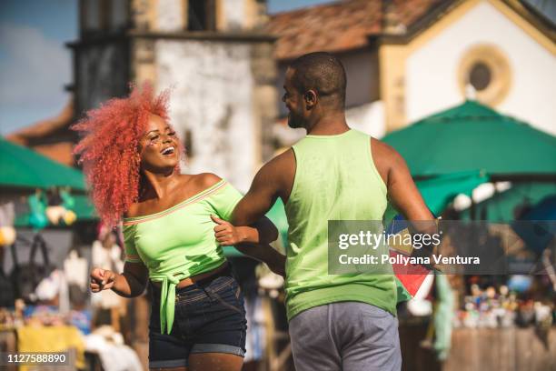 happy young couple dancing on the street - brazilian carnival stock pictures, royalty-free photos & images