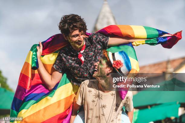 homosexual couple flag with rainbow flag - lgbtqia pride event stock pictures, royalty-free photos & images