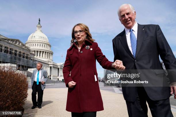 Former Rep. Gabby Giffords walks with Rep. Mike Thompson as she arrives to join Democratic lawmakers in support gun background checks legislation...
