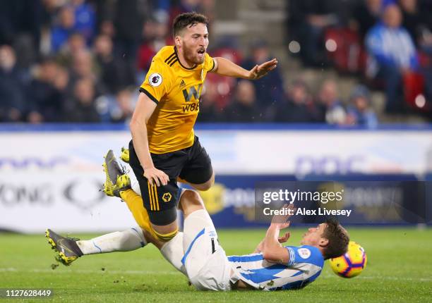 Matt Doherty of Wolverhampton Wanderers is challenged by Eric Durm of Huddersfield Town during the Premier League match between Huddersfield Town and...