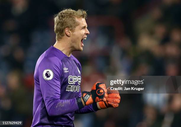 Jonas Lossl of Huddersfield Town celebrates as Steve Mounie scores his team's first goal during the Premier League match between Huddersfield Town...