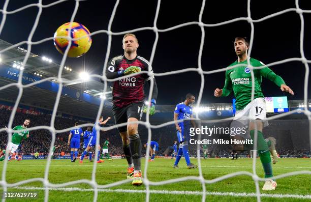Glenn Murray of Brighton and Hove Albion fethces the ball ahead of Kasper Schmeichel of Leicester City as Davy Propper of Brighton and Hove Albion...
