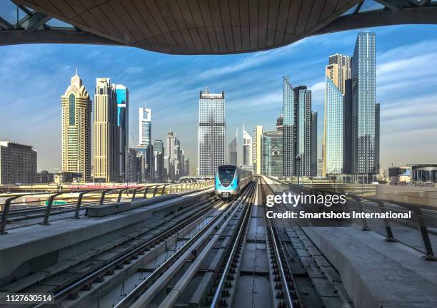 dubai driverless metro with futuristic city skyline on background in dubai, uae - dubai metro stockfoto's en -beelden