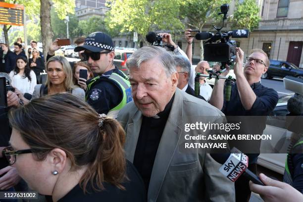 Cardinal George Pell makes his way through media as he arrives at court in Melbourne on February 27, 2019. - Cardinal George Pell arrived in court,...
