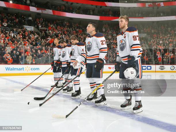 Connor McDavid, Milan Lucic, Kris Russell, Ty Rattie and Darnell Nurse of the Edmonton Oilers stand on the blue line during the National Anthem prior...