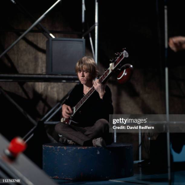 English musician and guitarist Brian Jones of rock group The Rolling Stones plays a sitar during a performance by the band on the set of the...