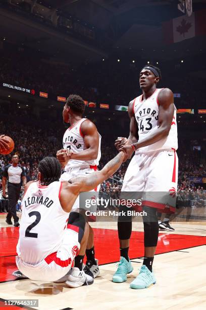 Kyle Lowry and Pascal Siakam help Kawhi Leonard of the Toronto Raptors from the floor during the game against the San Antonio Spurs on February 22,...