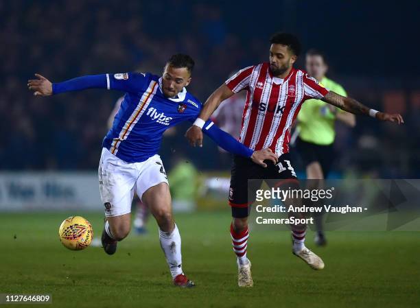 Exeter City's Kane Wilson shields the ball from Lincoln City's Bruno Andrade during the Sky Bet League Two match between Lincoln City and Exeter City...