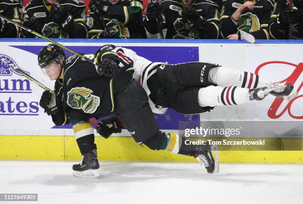 Zachary Roberts of the Guelph Storm lunges at Adam Boqvist of the London Knights as he misses a hit in the third period during OHL game action at...